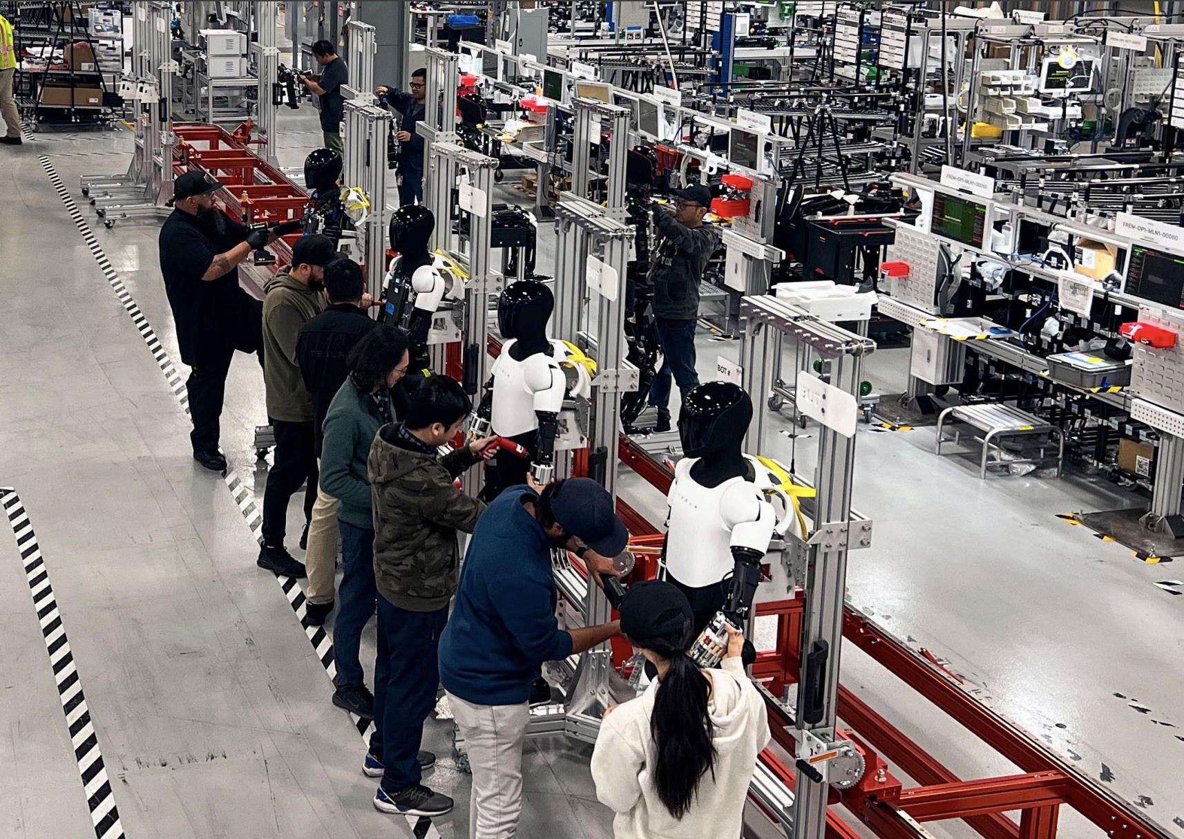 Tesla Optimus Units Line Up in Fremont Pilot Production Line