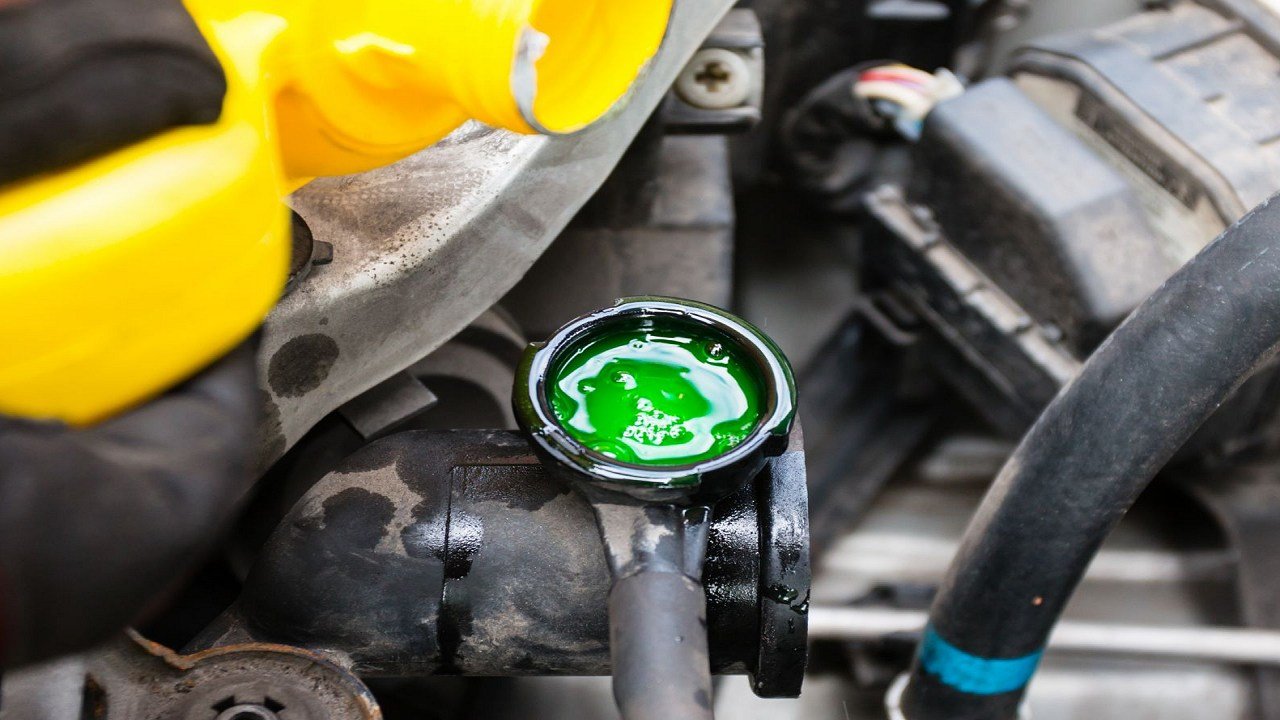 How do I check the engine coolant level?