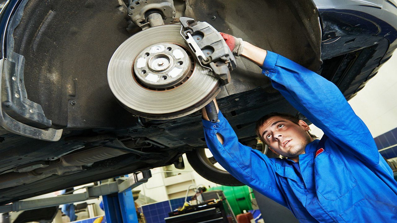 How do I check the condition of my car's brake pads?
