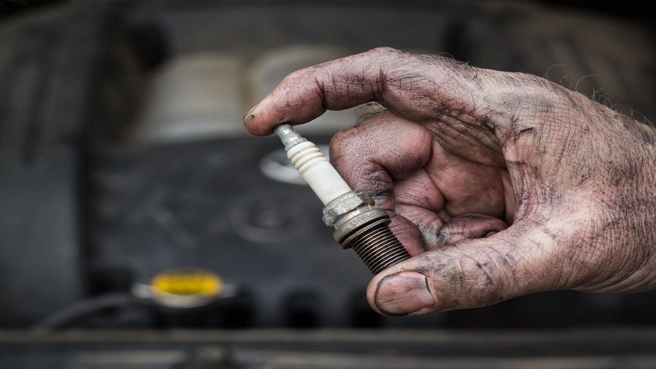 How do I replace a faulty spark plug in my car?
