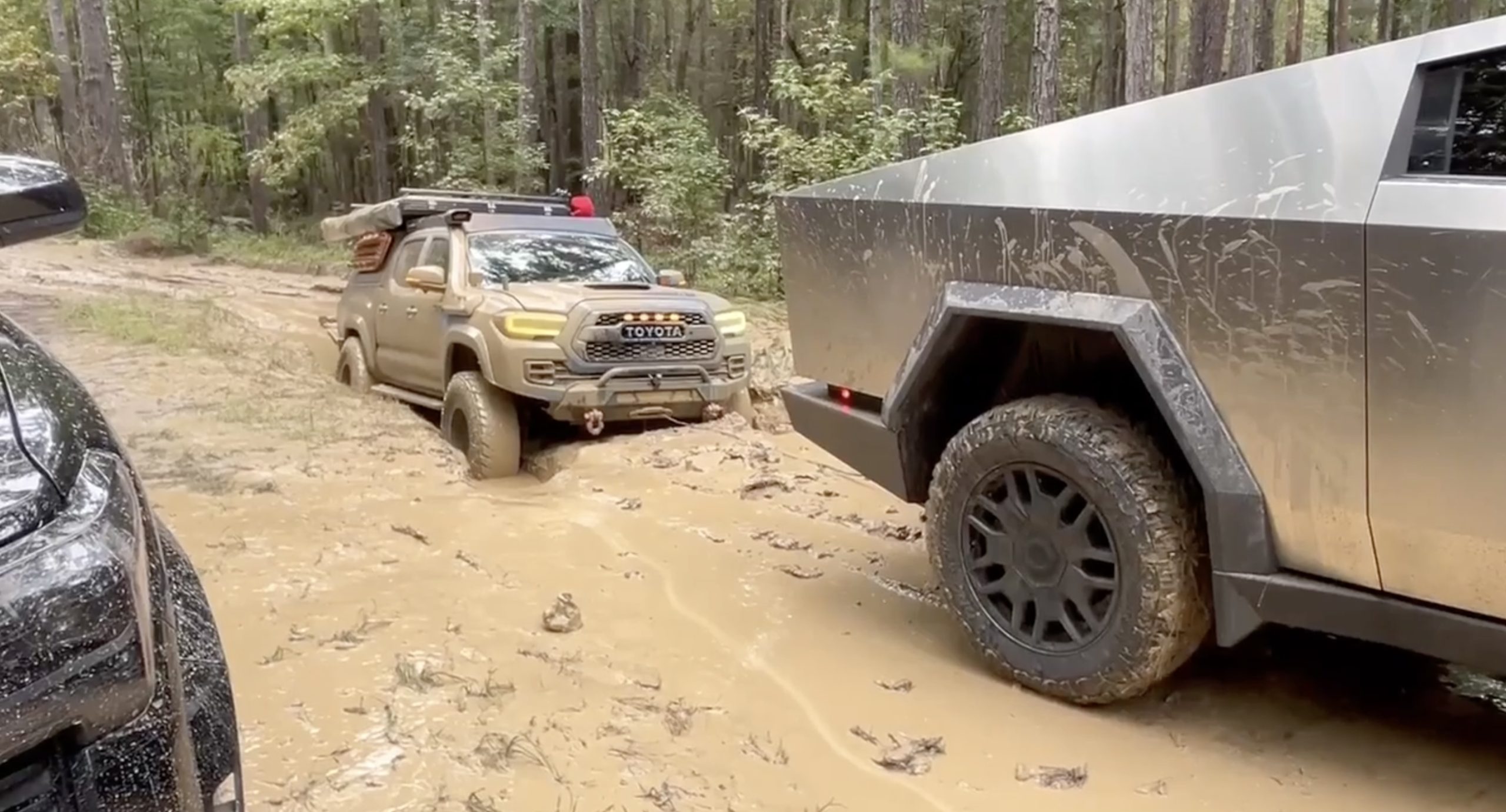 Tesla Cybertruck Conquers Muddy Hole Helps Out Stuck Toyota Pickup